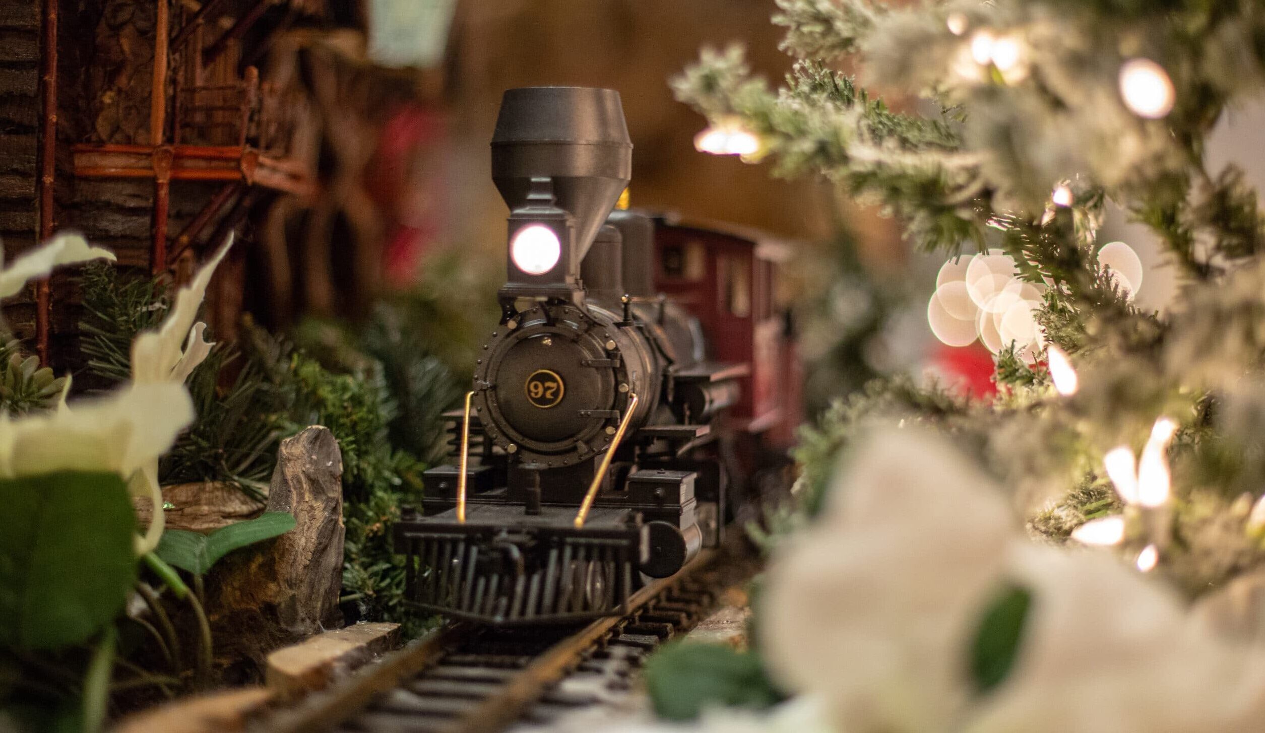 Miniature of a lodge in the mountains by a train track at the Eiteljorg Jingle Rails Exhibit