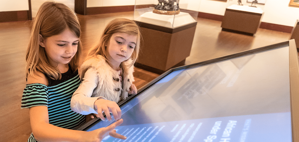 Two young girls viewing an exhibit at the Eiteljorg Museum