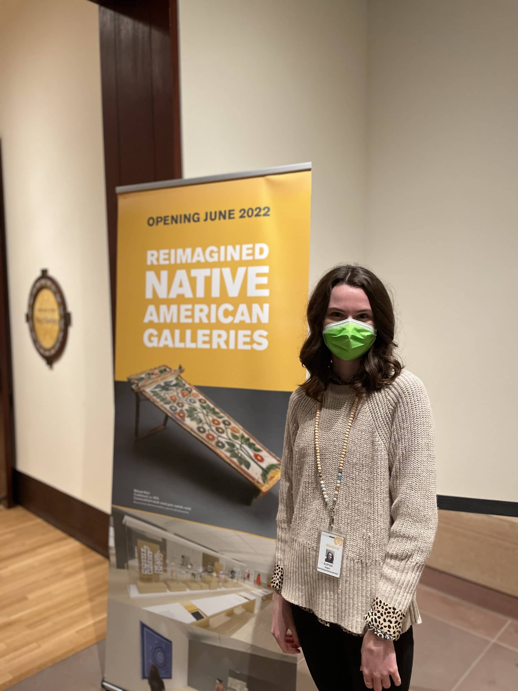 sophia_jaegly_eiteljorg_fall_marketing_intern_2021_in_front_of_project_2021_sign